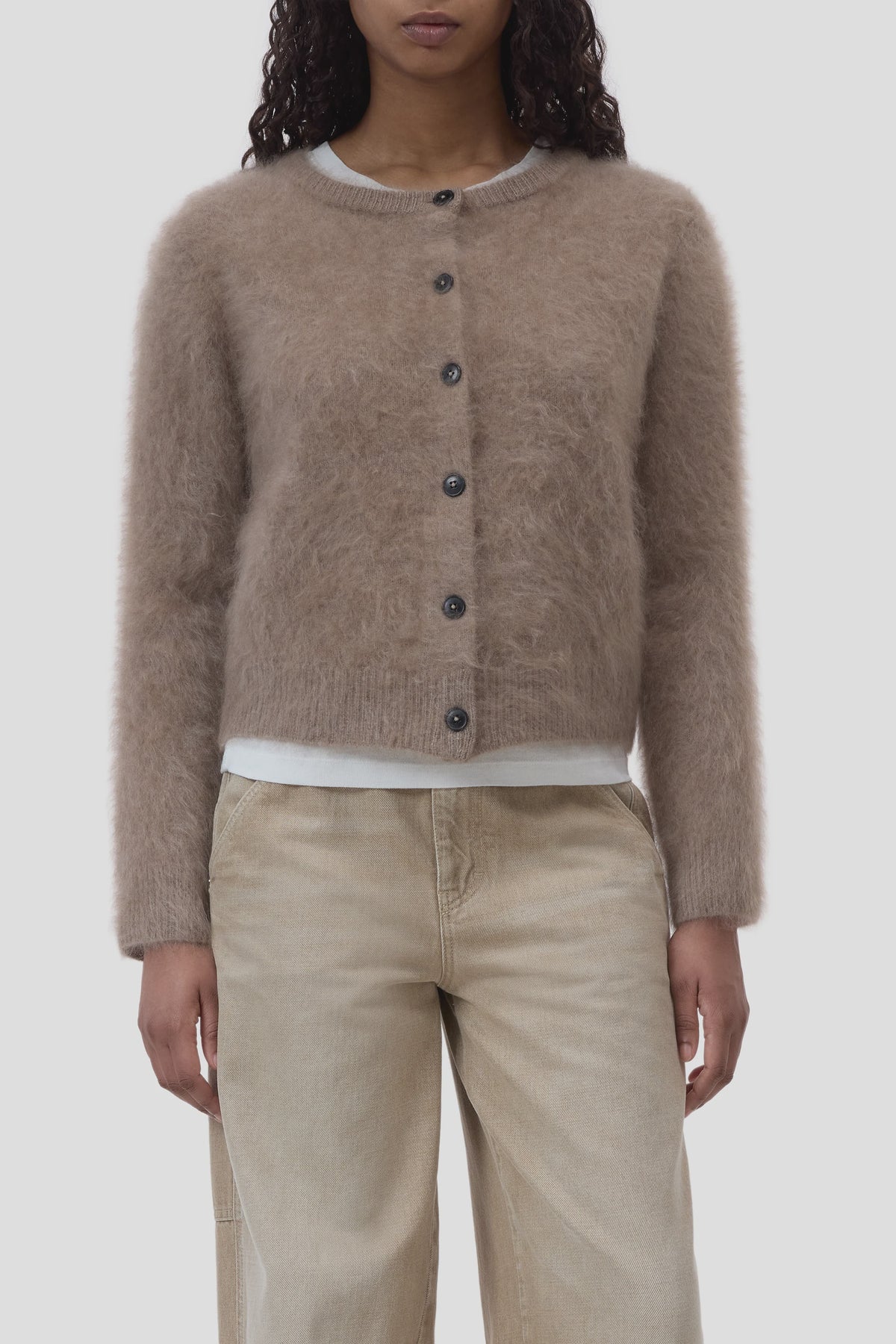 CLOSED crew neck cardigan in beige, layered over white shirt and jeans, modern casual style.