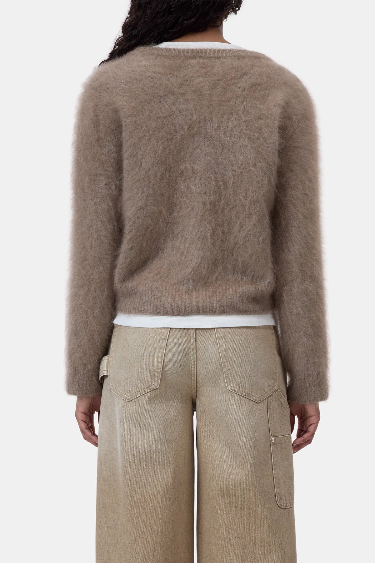 CLOSED crew neck cardigan in beige, shown from the back, paired with wide-leg pants against a plain backdrop.