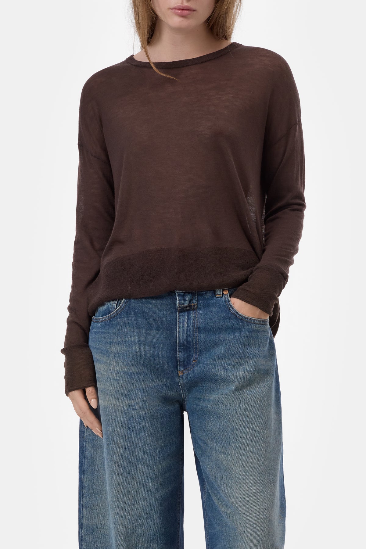 CLOSED crew neck long sleeve top in ivory with blue jeans, model standing against a white background.