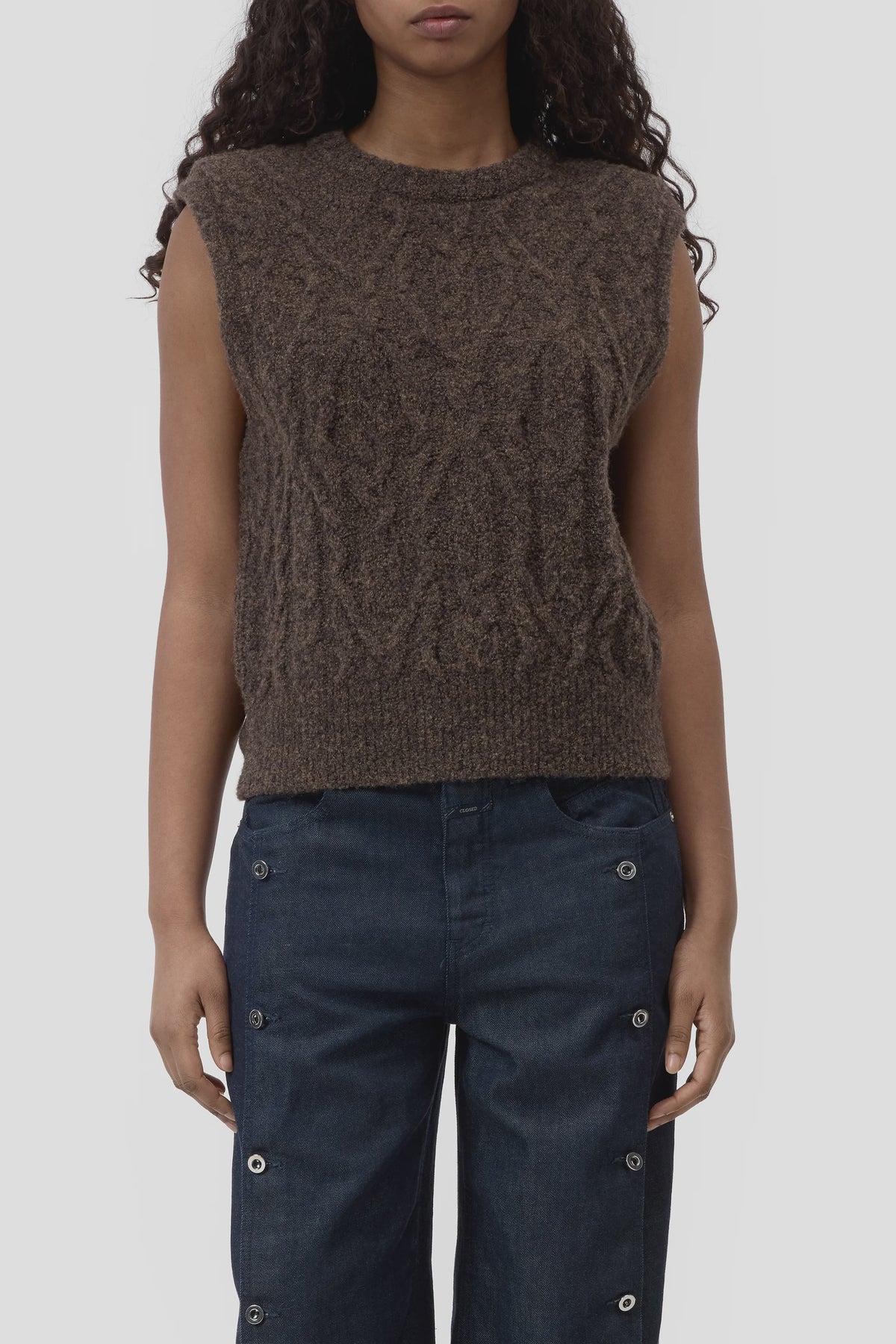 Brown CLOSED crew neck vest styled with high-rise dark jeans with metallic grommet accents from Bungalow Furniture.