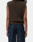 Brown cable knit CLOSED vest with crew neck, styled with dark blue jeans, back view.