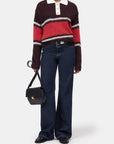CLOSED Polo with rugby stripes, paired with wide-leg jeans and black accessories, styled for a modern casual look.
