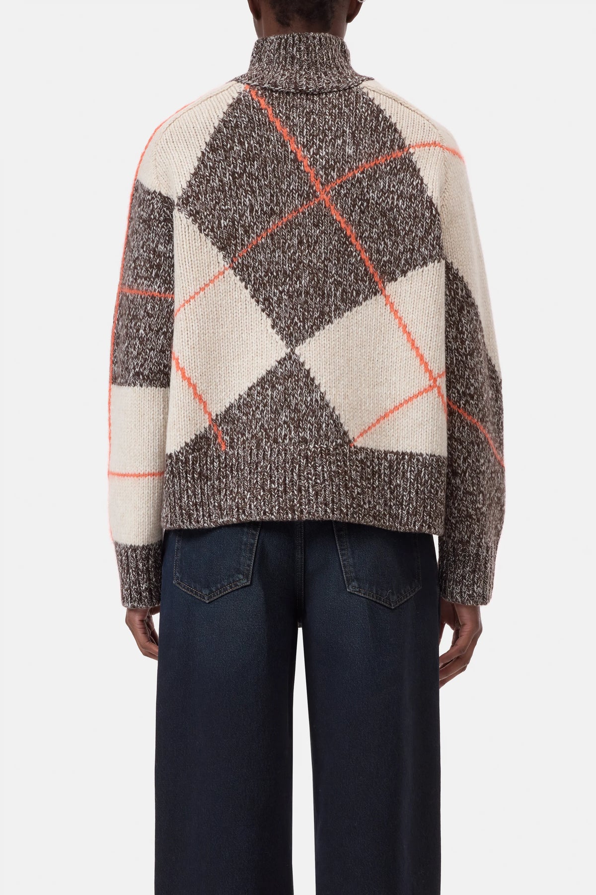 Wide-leg jeans and CLOSED ArgyleR chunky wool sweater in brown, cream, and orange argyle pattern, back view.