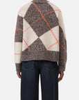 Wide-leg jeans and CLOSED ArgyleR chunky wool sweater in brown, cream, and orange argyle pattern, back view.