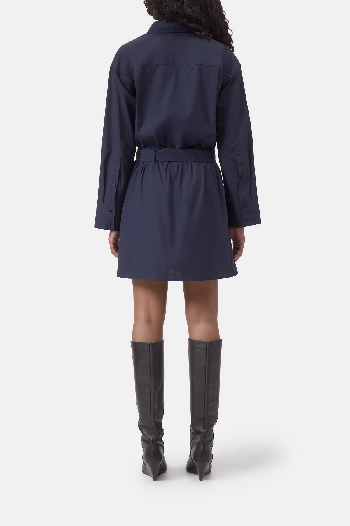Navy belted shirt dress by CLOSED, back view, styled with knee-high black boots on white background.