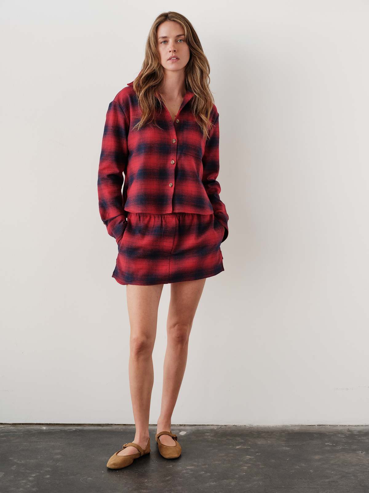 Red plaid MINI Skirt with matching shirt and tan slip-ons by Bungalow Furniture, styled by a white wall.