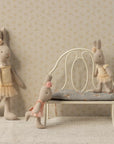 Maileg fabric bunny dolls with pastel outfits, styled in a cozy, softly colored nursery scene with vintage accents.