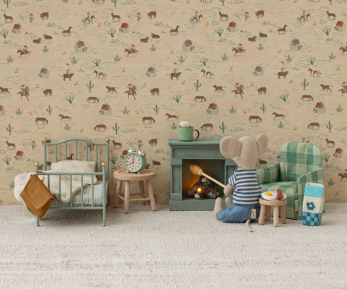 Vintage-style single bed with cozy bedding by Maileg, perfect for dollhouse playrooms and stuffed animals.