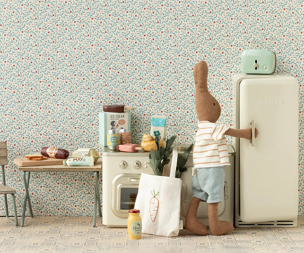 The Maileg Carrots in Bag by Maileg adds a cute touch next to the refrigerator and inspires imaginative kitchen play.