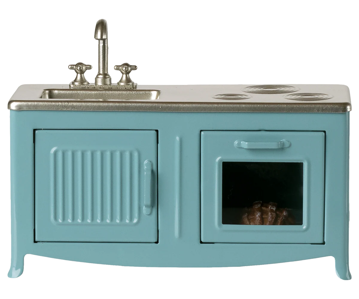 The Maileg Kitchen is a charming blue miniature playset featuring a silver sink and faucet, two stove burners, an oven door with a tiny item inside, and a left cabinet—perfect for any mouse house setup.