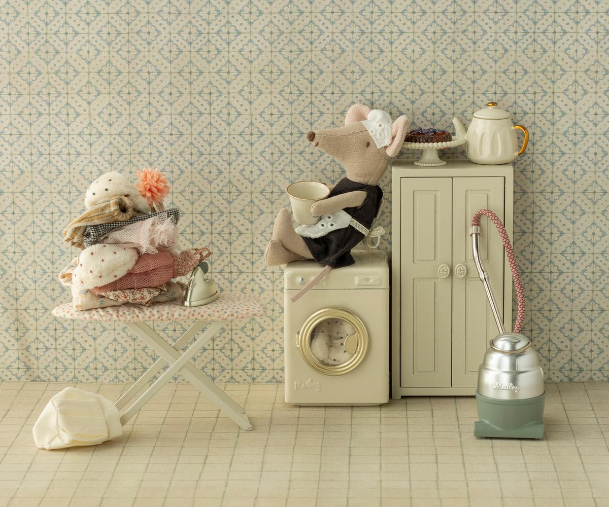 Maileg ironing mouse with iron and ironing board in a charming miniature laundry room setting.