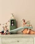 Maileg toy mice on teddy bear with Corner Cabinet, styled in pastel Mouse Hole Farmhouse by Bungalow Furniture & Accessories.