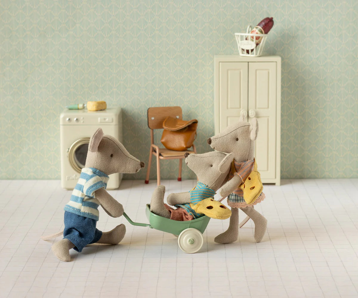 Maileg Little Sister Mouse w/ Bag by Maileg features a dressed toy mouse that can play in a miniature room filled with a washing machine, chair, cabinet, and basket—a charming addition to any imaginative play set.