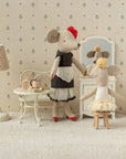 Maileg Beautician Mouse Mum in a dollhouse salon, stylishly dressed and seated at a vanity with magnetic paws.