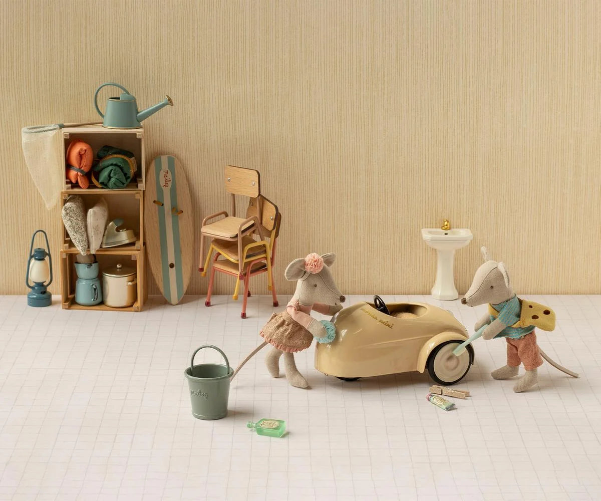 Maileg metal car, Mouse - Wheat, being washed by two toy mice with sponges in a playful setting.