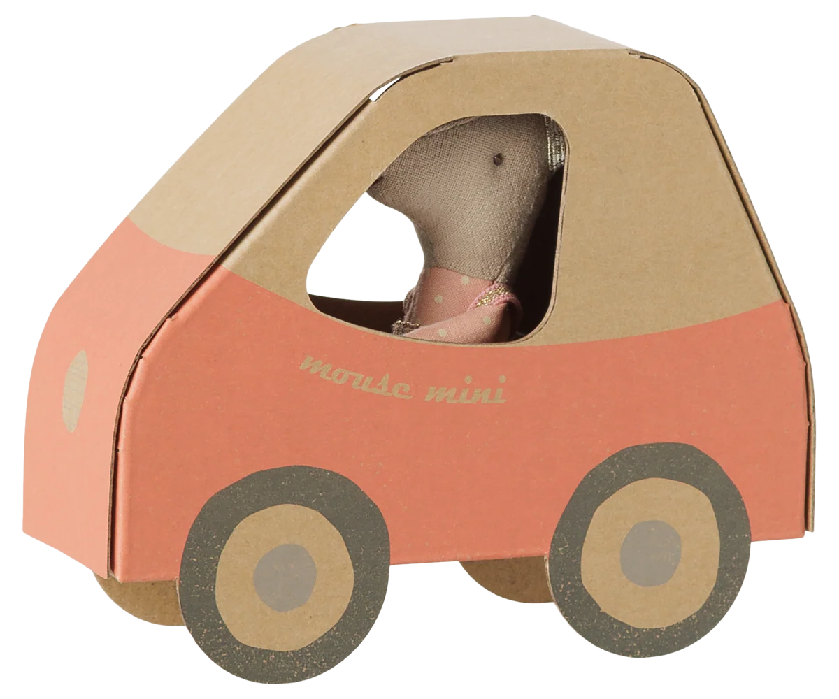 Little sister mouse in a glittery pink polka-dot dress inside a cardboard car by Bungalow Furniture &amp; Accessories.