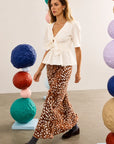 Hunter Bell NYC Suki Skirt in a bright, modern room with bold stacked spheres, styled with a classic white blouse.