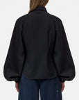 CLOSED Raglan Shirt in white with blue jeans, shown from the back. Casual modern style for everyday wear.
