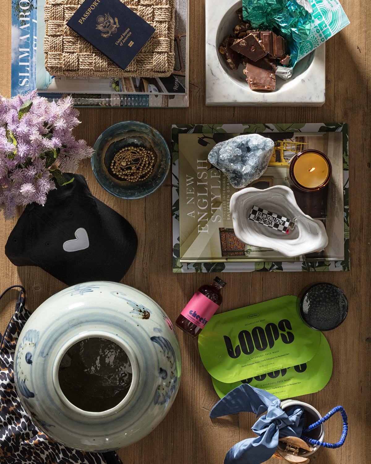 Cozy travel-inspired vignette on a wooden table styled by Bungalow Furniture & Accessories.