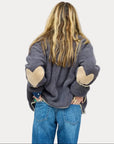 Kerri Rosenthal Coze Magoze jacket with tan heart elbows, styled with blue jeans, back view.