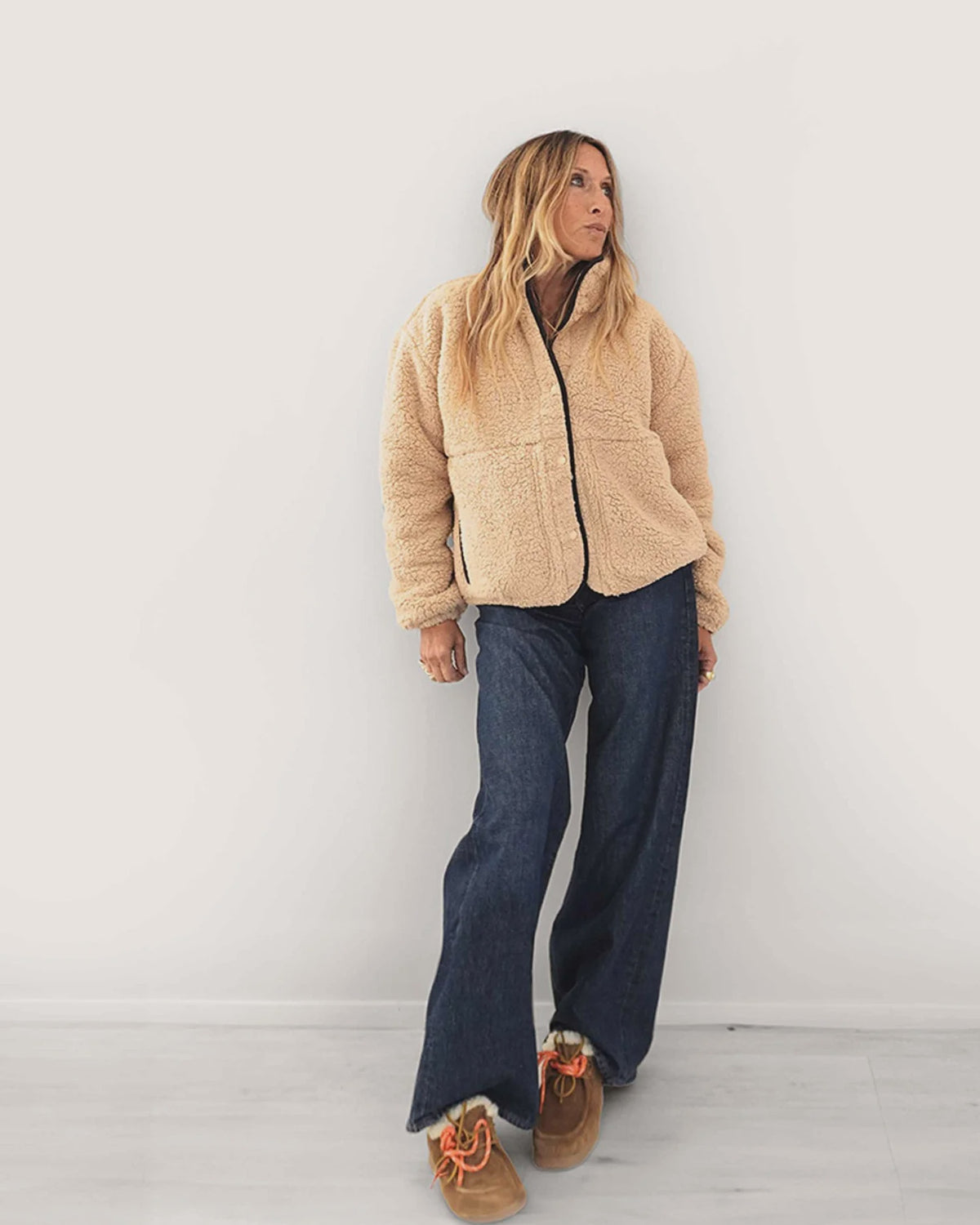 Kerri Rosenthal Coze Magoze jacket in tan with Imperfect Heart elbow patches, worn with wide-leg jeans and brown slip-ons.