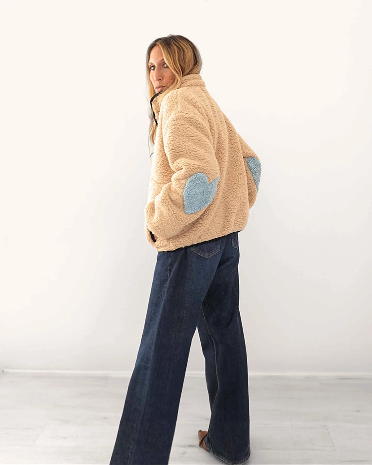 Kerri Rosenthal Coze Magoze jacket in tan with light blue Imperfect Heart elbow patches, paired with dark denim jeans.