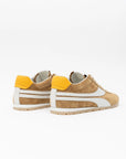 The ONCEPT Essex Sneaker, crafted in tan Italian premium calf suede with white stripes and soles plus yellow heel accents, is shown against a plain white background with the heels facing the camera.