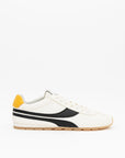 The Essex Sneaker by ONCEPT features white ultra-lightweight Italian calf suede, a black side stripe, yellow heel tab, white laces, and a tan rubber sole. Displayed on a plain white background.
