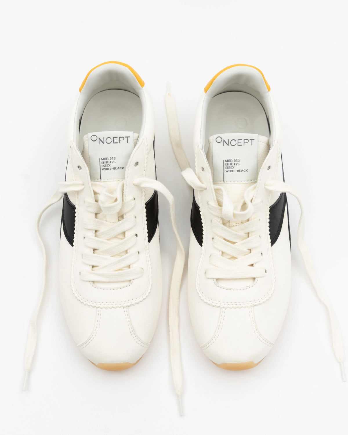 A pair of white Essex Sneakers from ONCEPT, ultra-lightweight with black side stripes and yellow accents, are shown from above. Both shoes are unlaced, revealing the ONCEPT label on the tongue and outward-spread laces.
