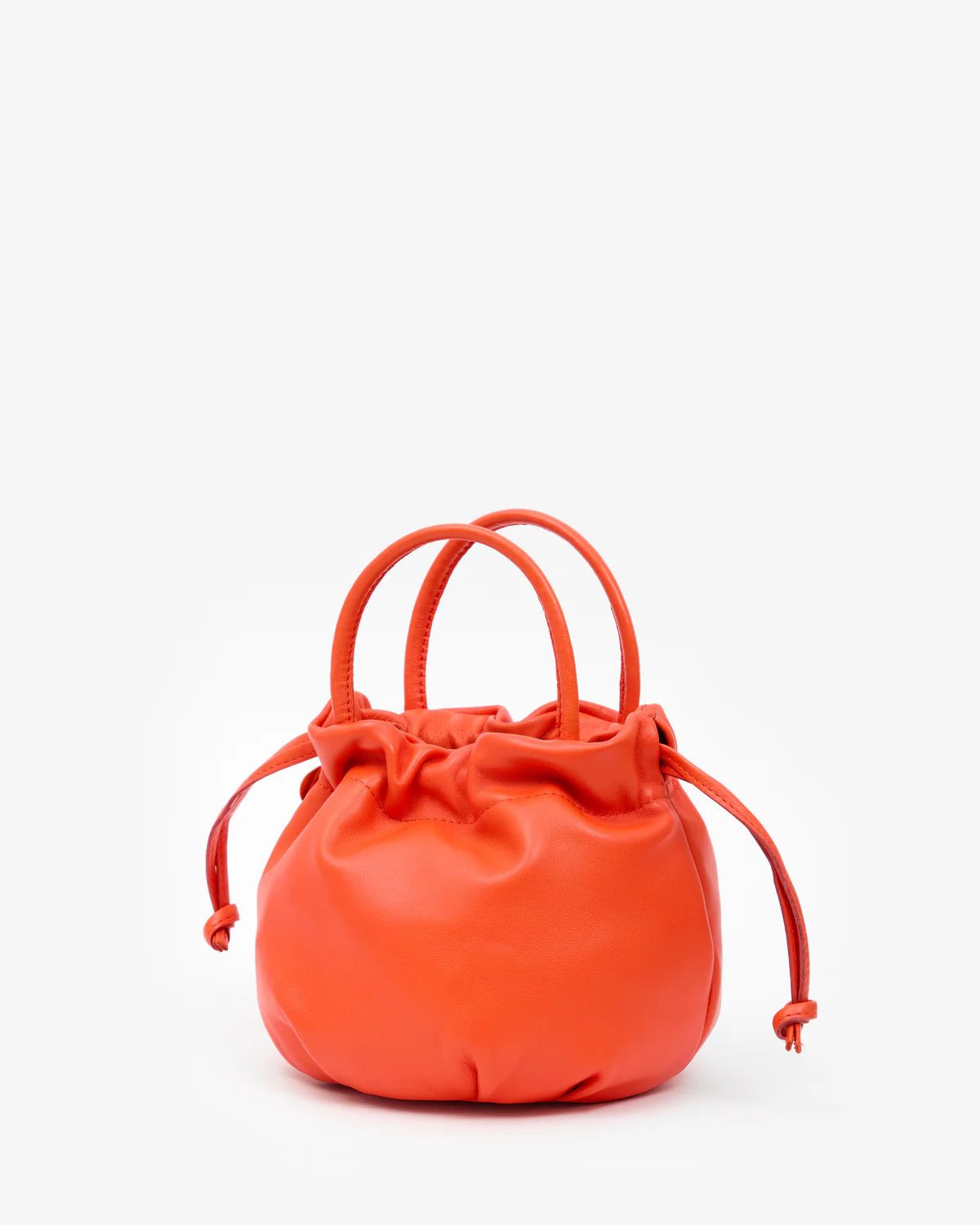 Round orange nappa leather bag with top handle and drawstring, Clare Vivier Emma style, on white background.