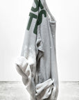 The A.W. Heather Bleachout Sweatshirt by Free City (sparrow, LLC) in light gray features hand-screen printed green partial text, white bleach-like spots, and "freecitysupershop" in black at the bottom, shown against a plain white background.