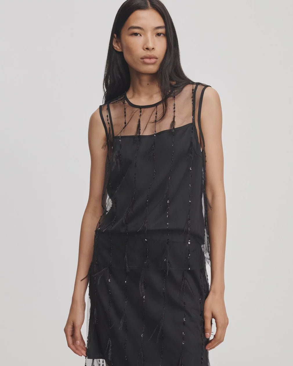 Black sleeveless organza tank by Rag & Bone featuring a sheer overlay with vertical bead and feather embellishments.