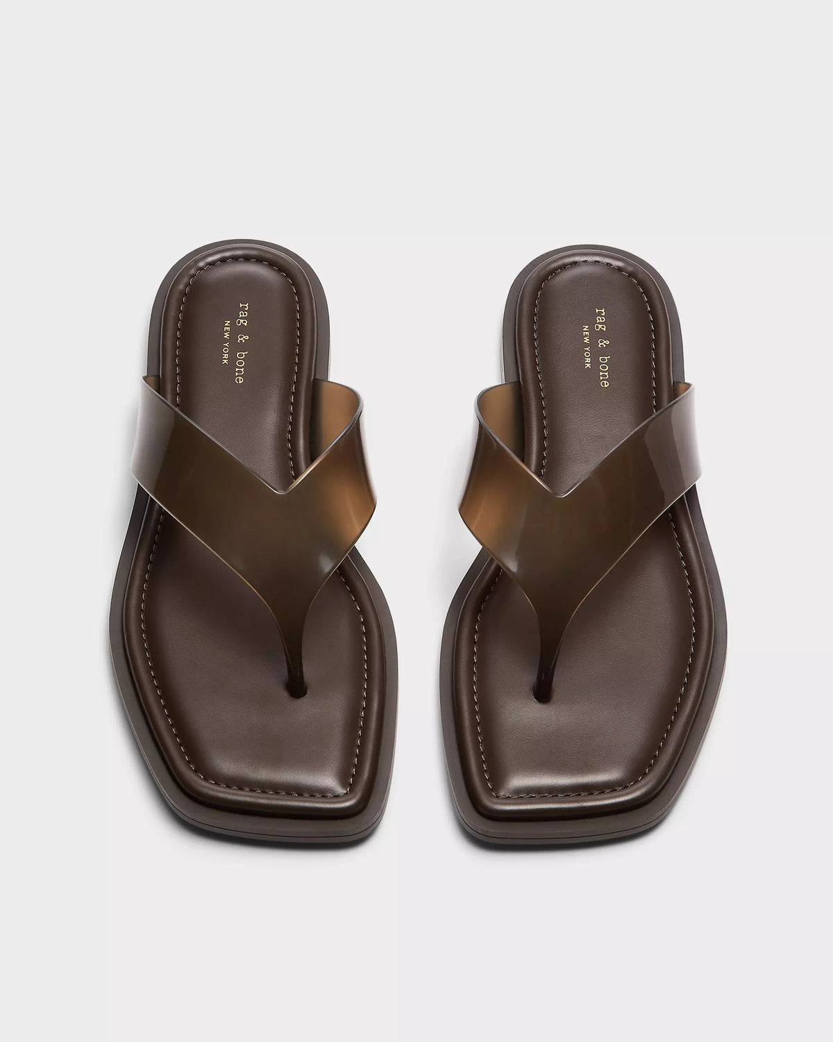 A pair of Rag & Bone gracie jelly thong sandals with brown, geometric square toes, glossy wide straps, and cushioned footbeds, shown side by side on a light background.
