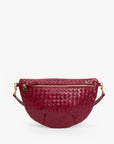 Handwoven garnet leather crossbody with gold zipper and round charm, Clare Vivier Grande Fanny S26.