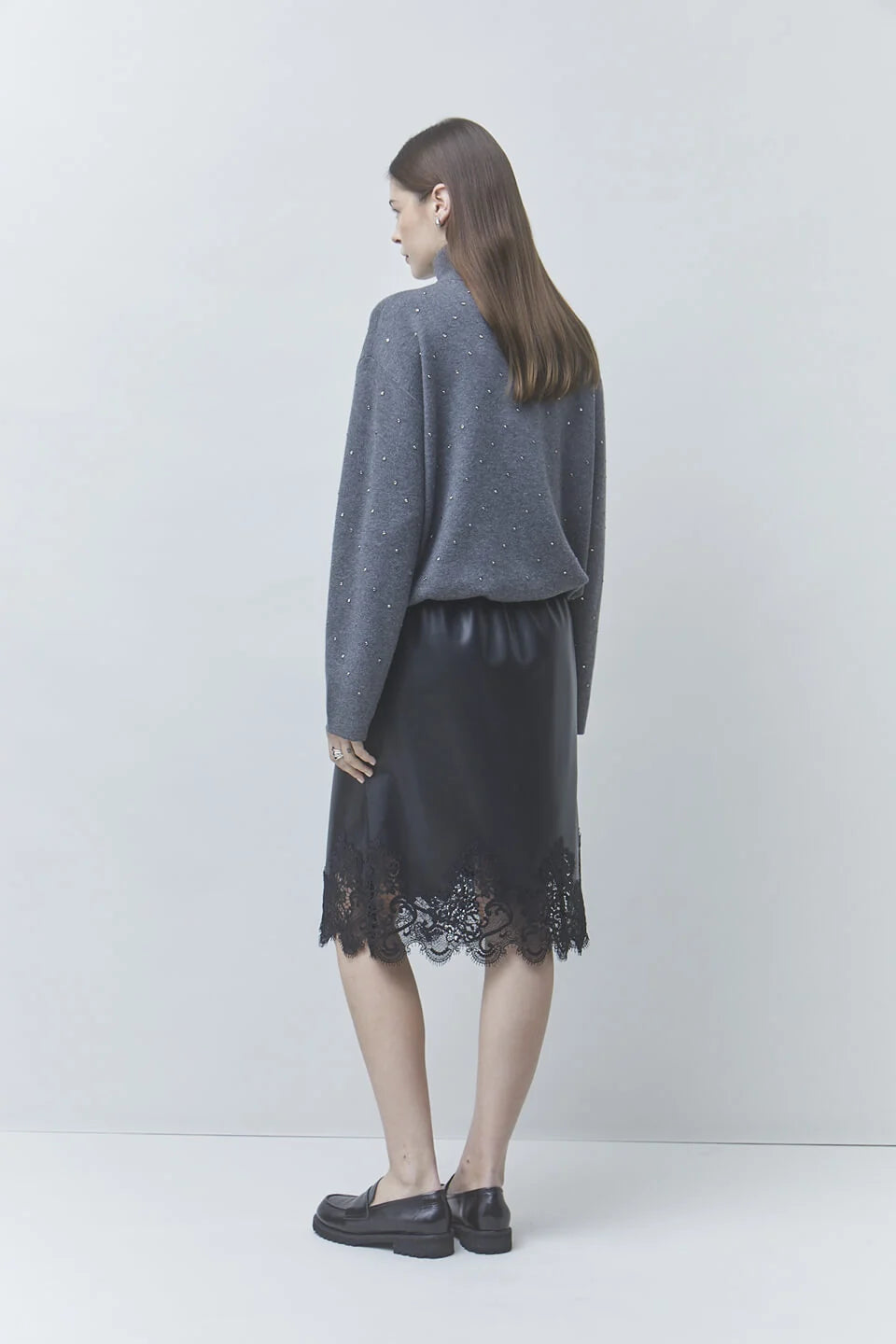 Pristo dark grey high-collar sweater and black lace skirt by SUNCOO, styled with a light background.