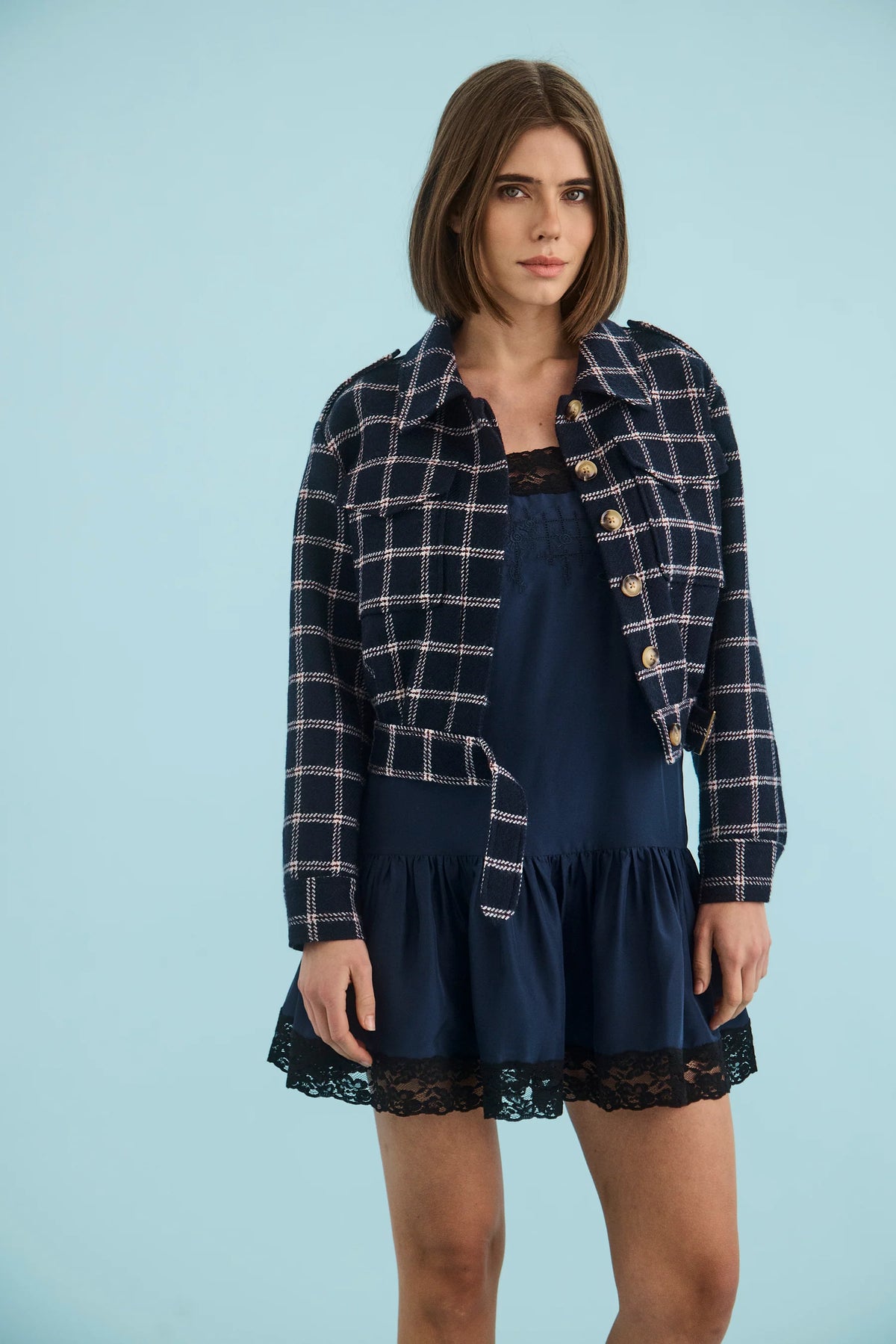 Hunter Bell NYC Dorrington Jacket in blue styled over a dress, modeled against a light blue background.
