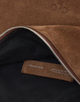 Brown suede halfmoon bag with silver zipper and adjustable strap by CLOSED, partial logo visible.