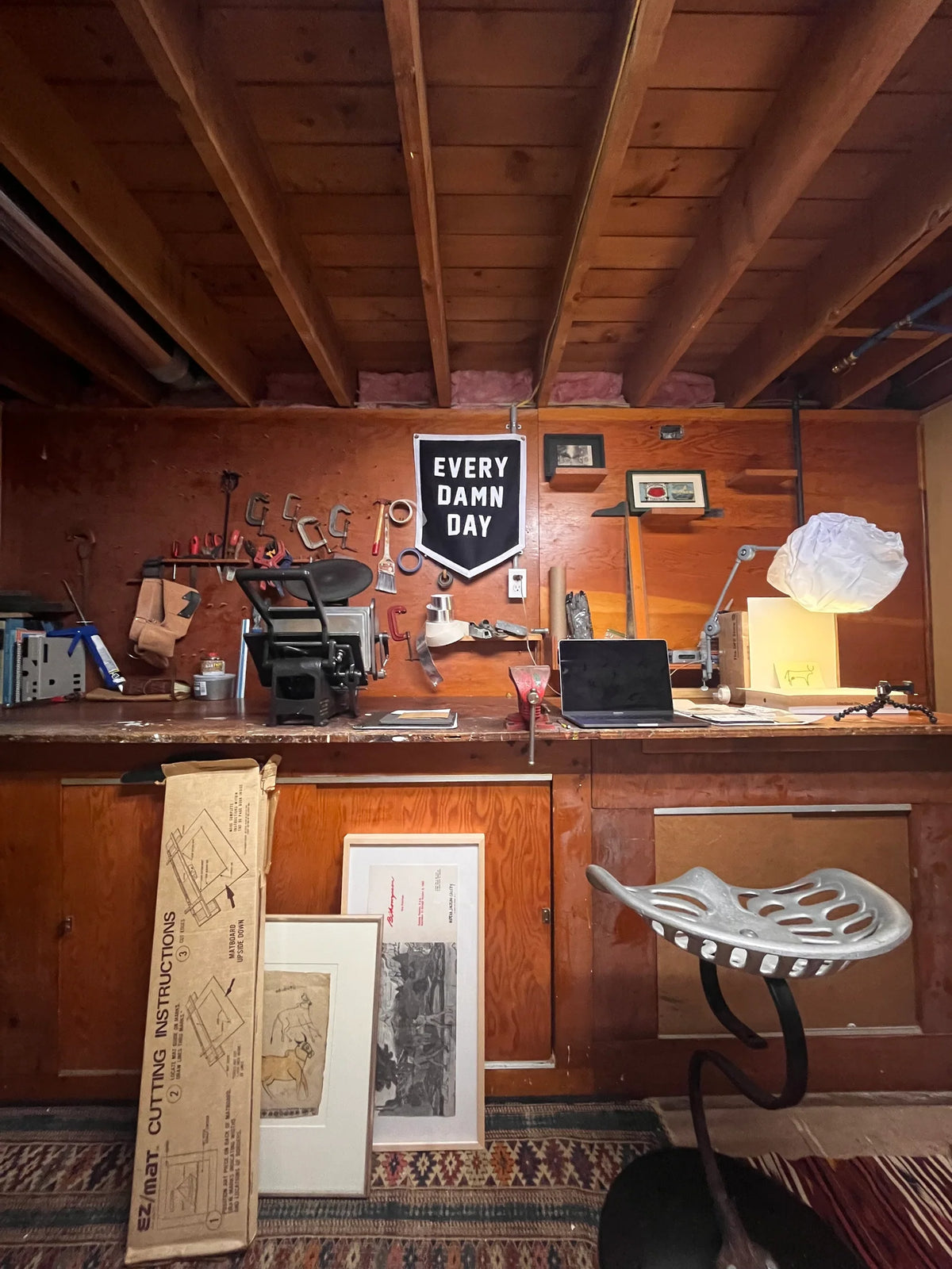 Bungalow Furniture &amp; Accessories workshop featuring modern decor, tools, and the Faire Every Damn Day Camp Flag.
