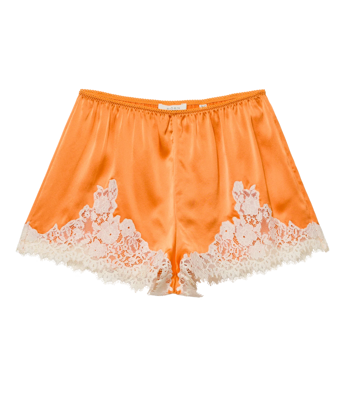 The DOEN Iona Short is a high-waist orange satin pair, featuring white floral lace trim along the hem and sides, shown on a white background.