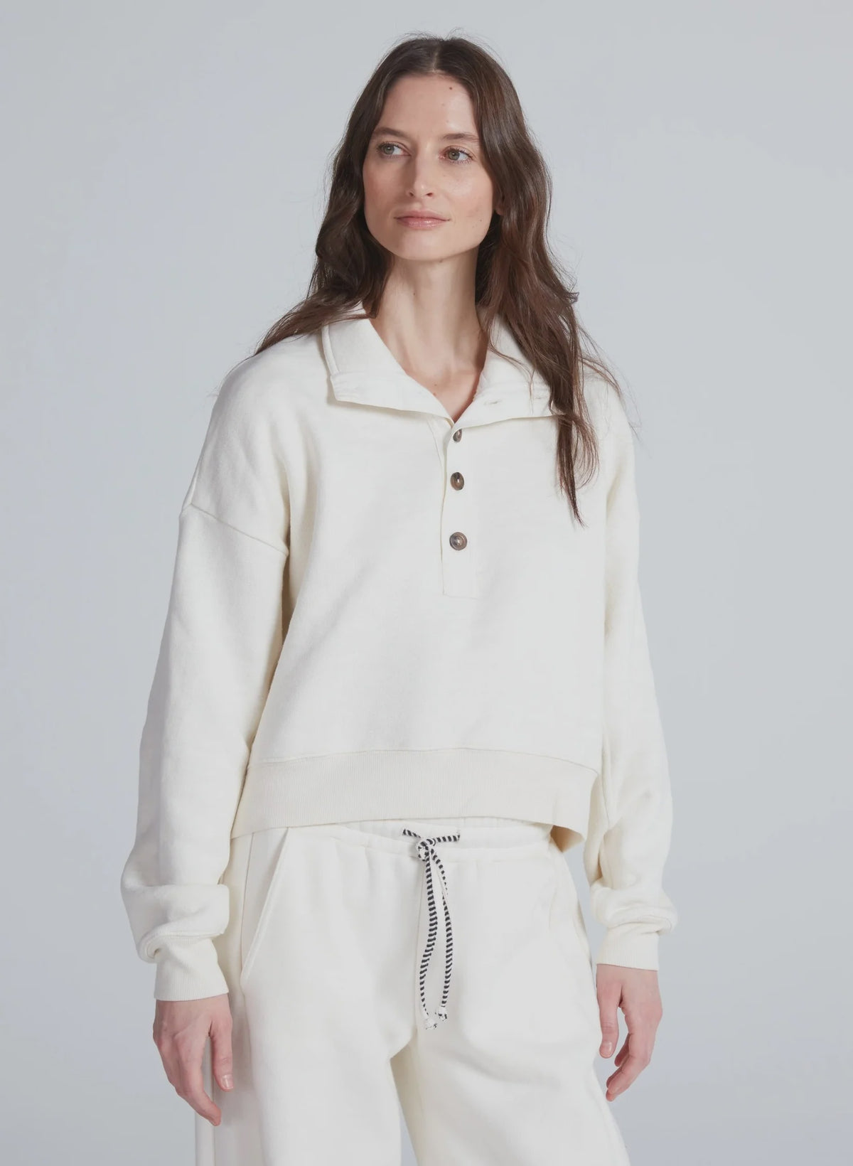 ASKK Leroy Sweatshirt in light gray, relaxed fit, modeled against a plain gray background.