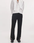 Rag & Bone Irina Ponte mid-rise wide-leg track pants in black with white and burgundy side stripes, paired with a shirt.