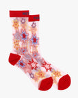 The Step Up Sock by Mother features translucent grey fabric with red heels, toes, and cuffs, colorful star patterns in red, yellow, and blue, plus blue and red text along the cuff's top edge.