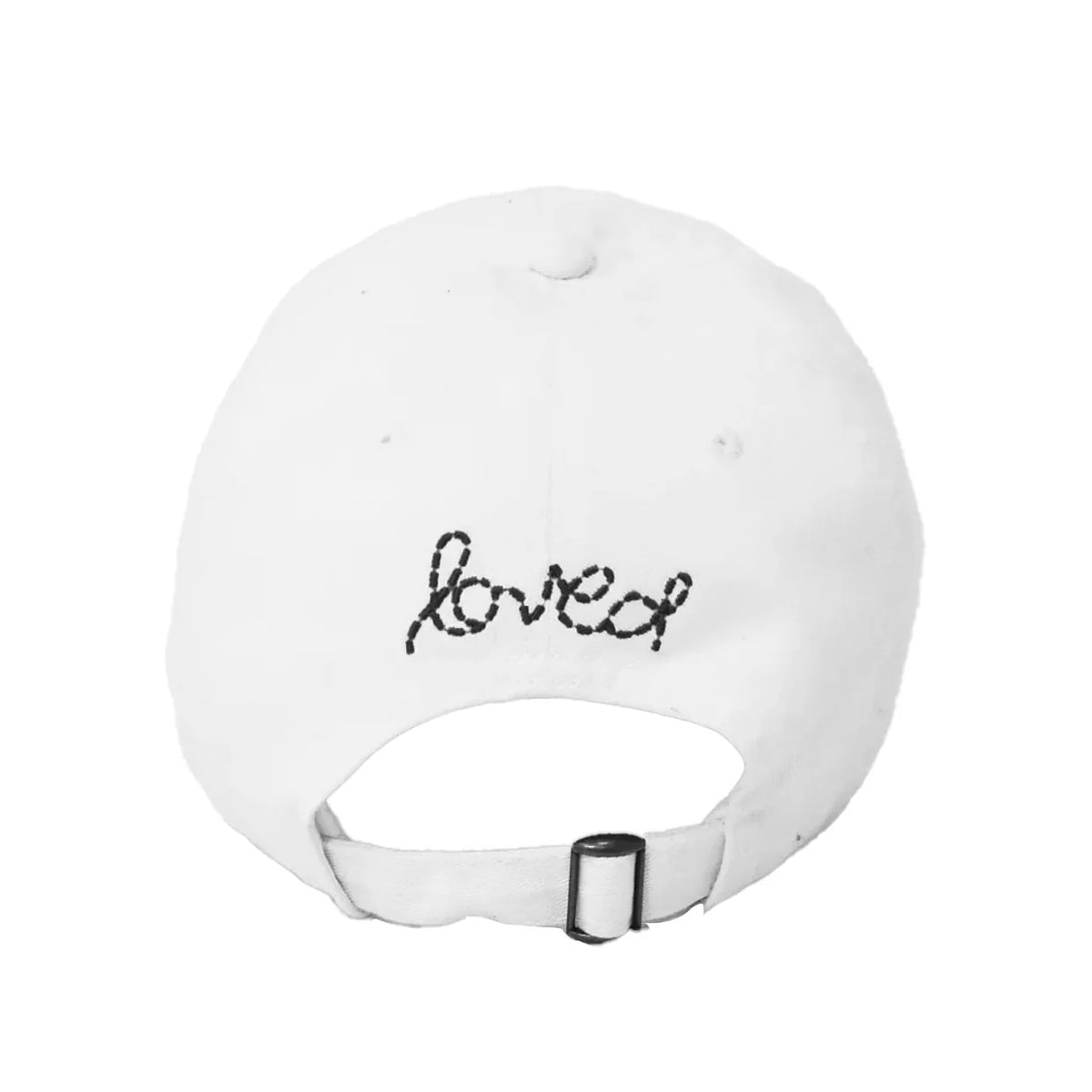 The Baseball Hat Heart Patch by Kerri Rosenthal is a white cap viewed from the back, with "loved" in black script and a small heart above the adjustable strap, reflecting popular styles.