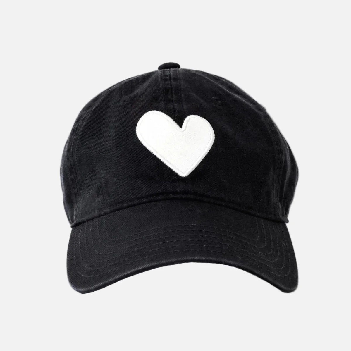 The KR Imperfect Heart Hat by Kerri Rosenthal is a black baseball cap with a large embroidered heart patch on the front, shown against a plain light gray background.