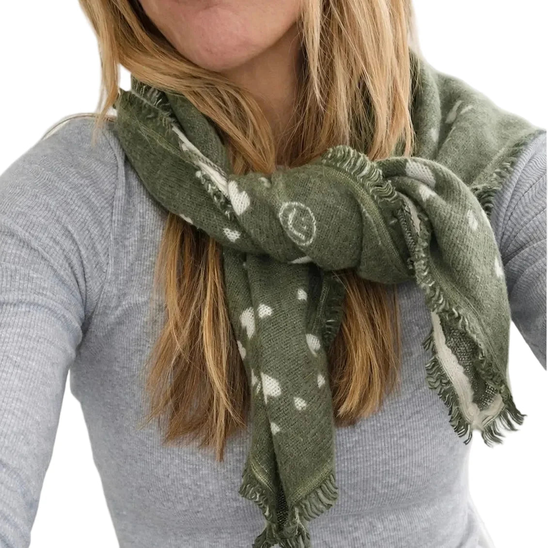 Olive green KR Cashmere Bandana with white heart pattern and frayed edges worn around the neck.