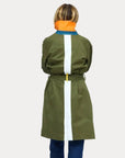 Kerri Rosenthal olive trench with white stripe and orange collar, shown styled with blue jeans.