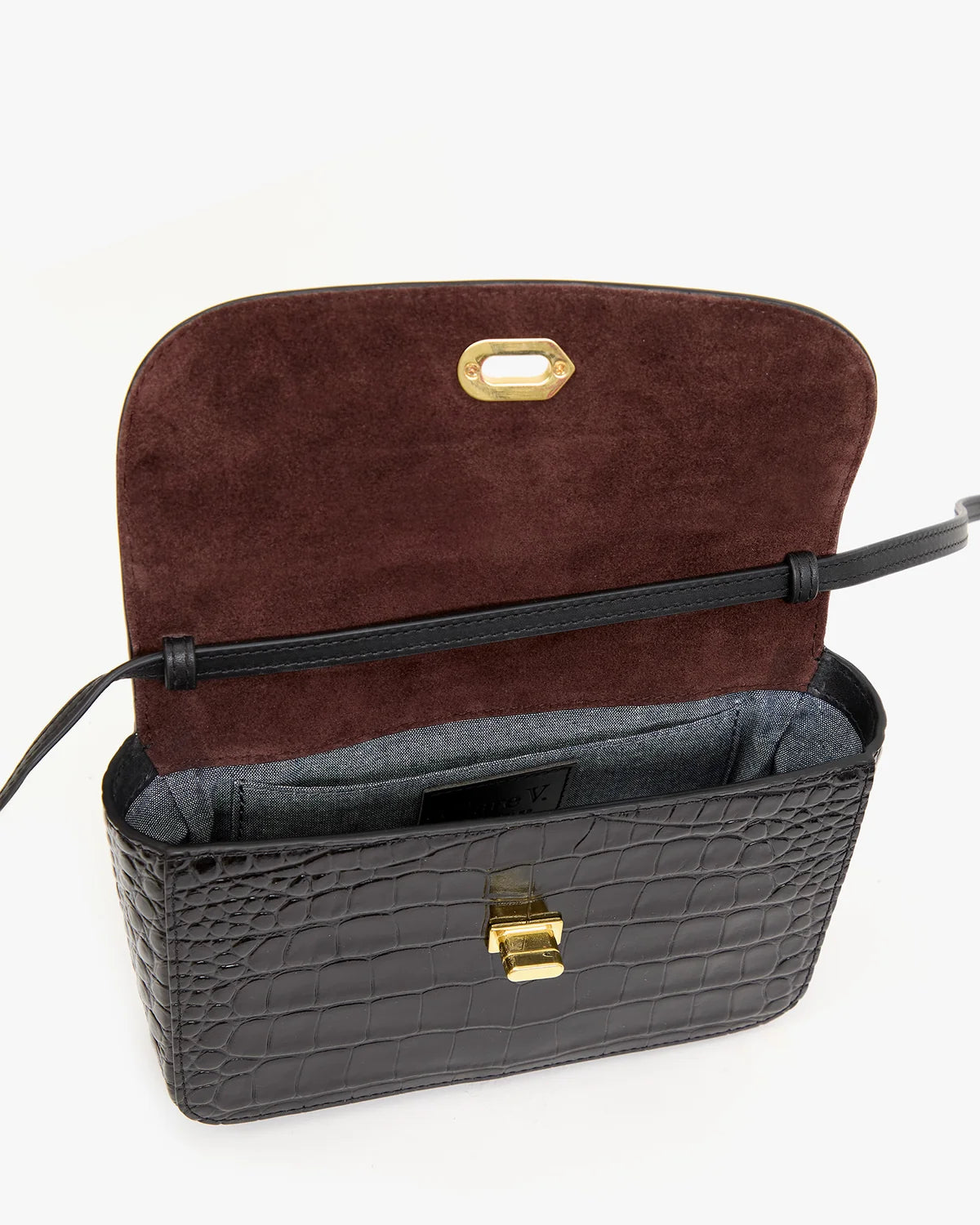 Black croco-embossed Italian leather crossbody bag with open flap, burgundy lining, and gold clasp by Clare Vivier.