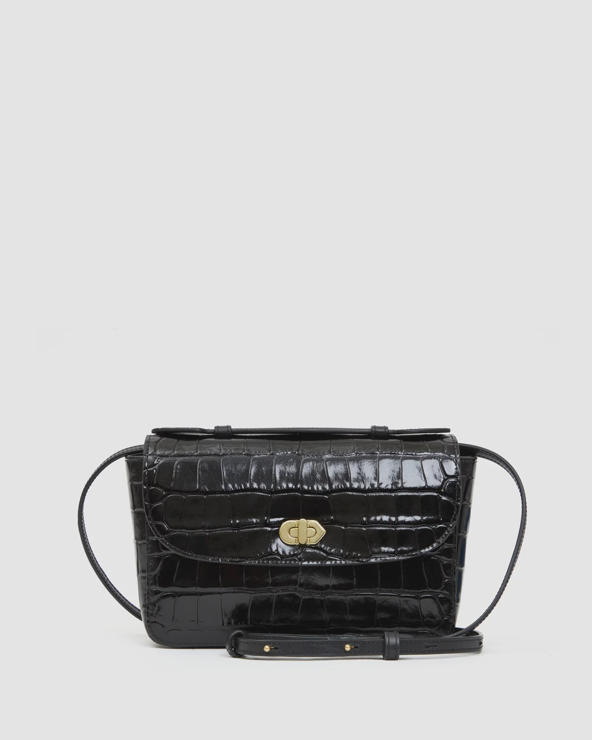Black croco-embossed Italian leather Kathryn crossbody bag by Clare Vivier featuring a gold turn-lock clasp.