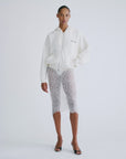 MIA white hoodie by Love Stories styled with lace skirt and black heels, minimal background for a modern look.