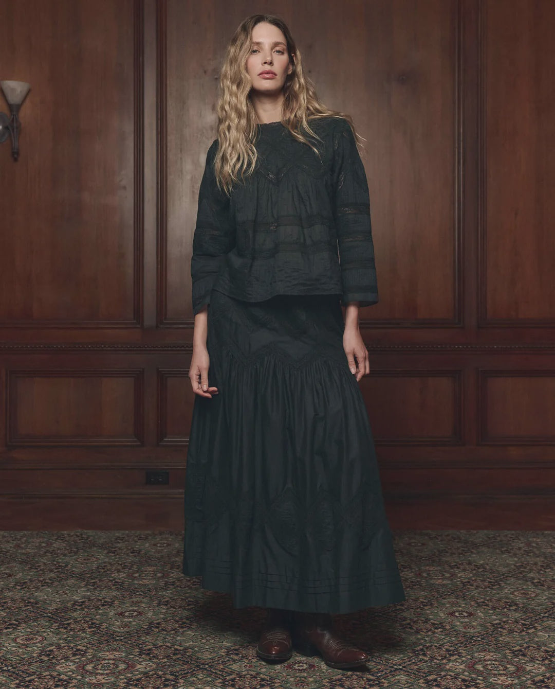 Lattice Lace Victorian Skirt by The Great Inc. in a classic wood-paneled room with patterned carpet.